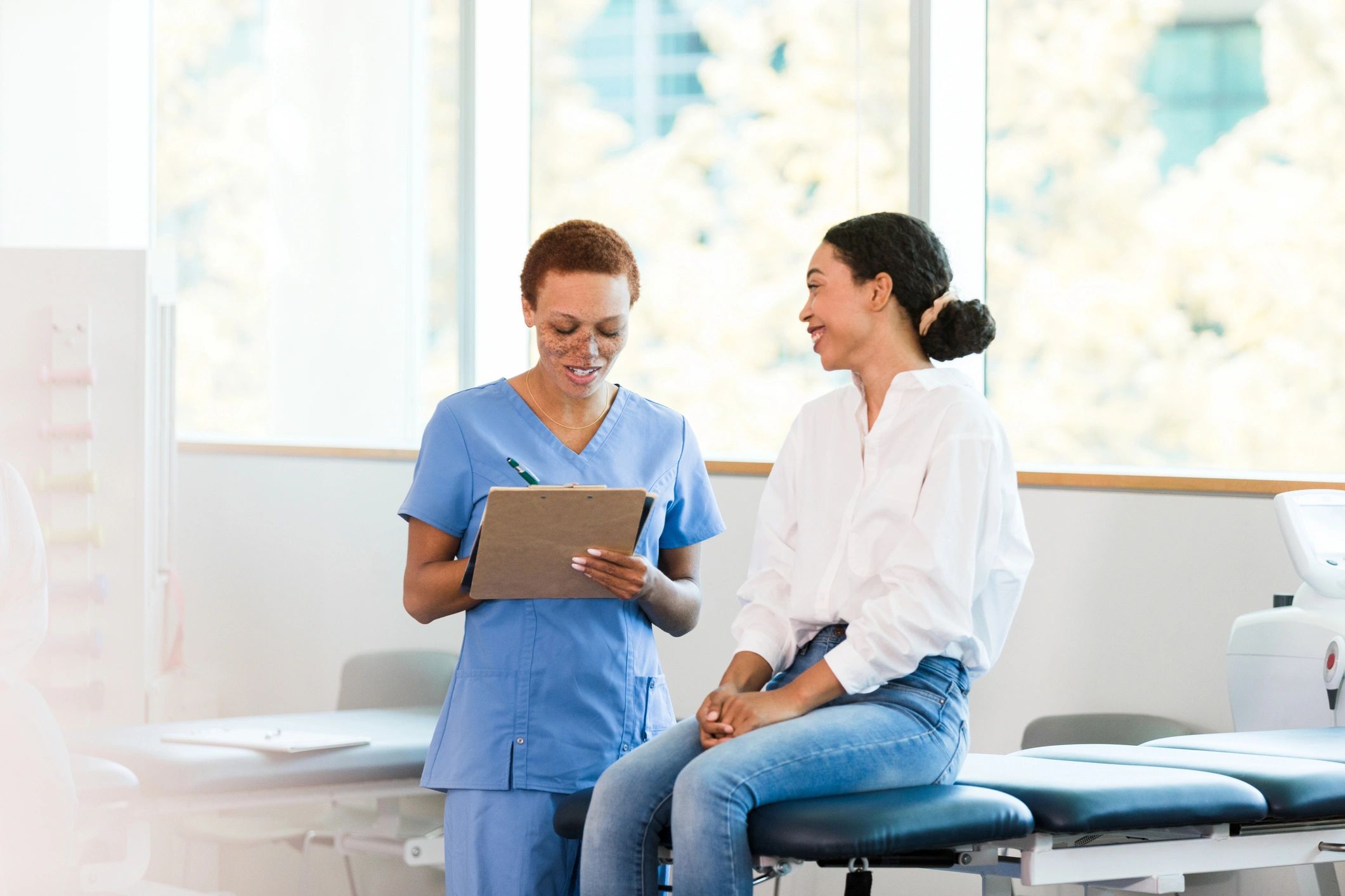 Friendly healthcare professional speaking with a patient