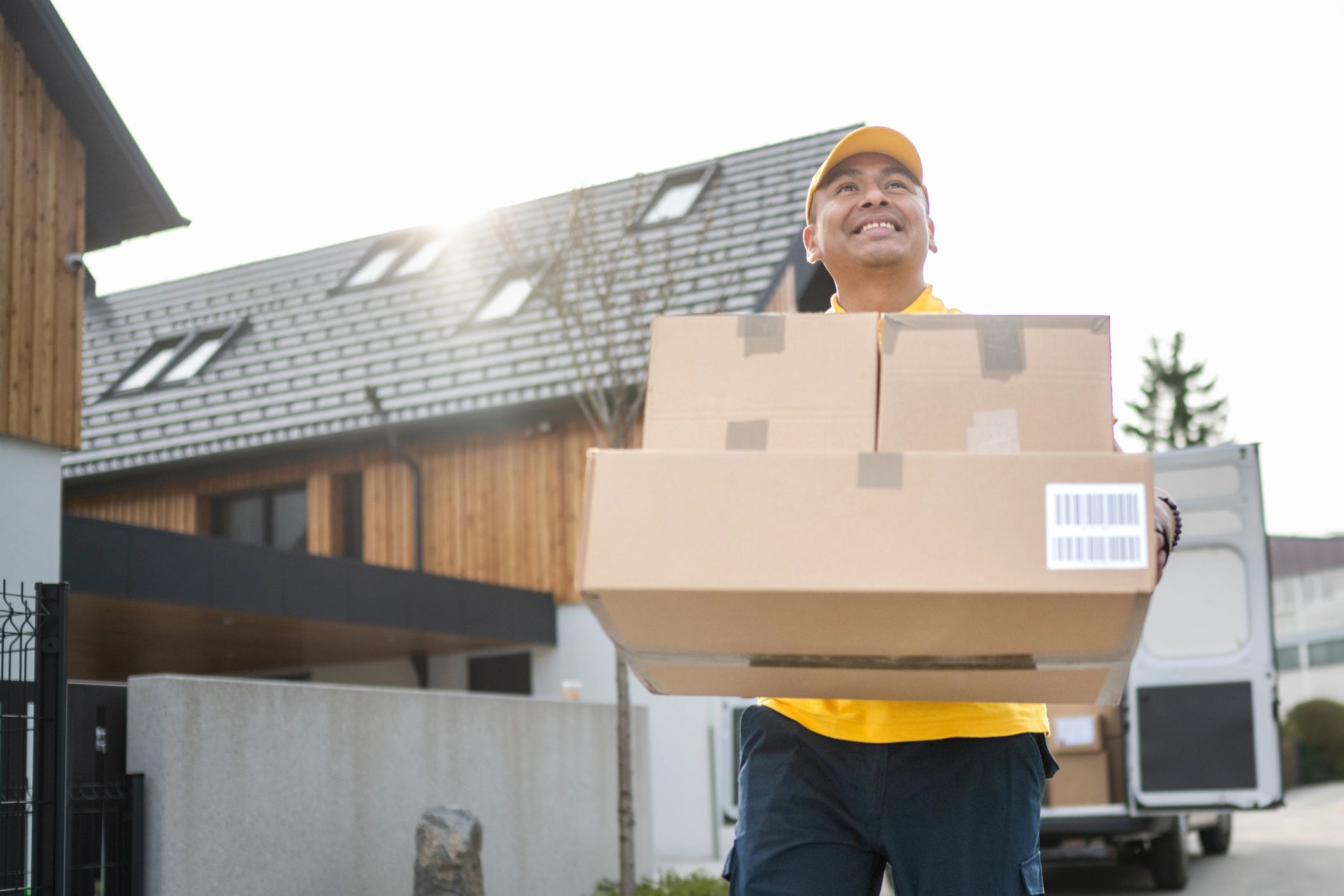 Delivery professional carrying packages for home delivery